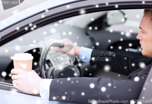 Image of close up of man drinking coffee while driving car