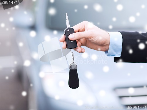 Image of close up of man with car key outdoors