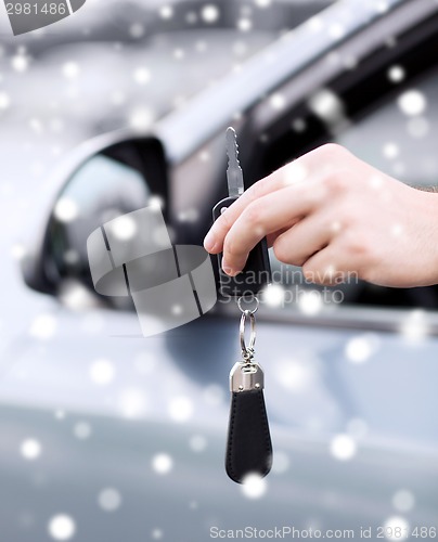 Image of close up of man with car key outdoors