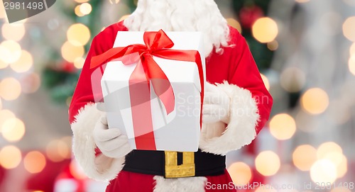 Image of man in costume of santa claus with gift box
