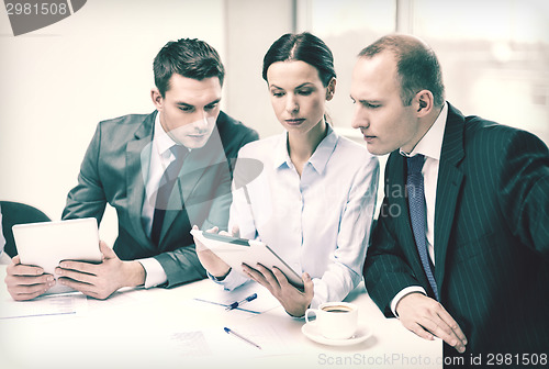 Image of business team with tablet pc having discussion