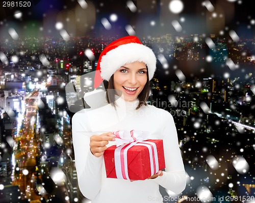 Image of smiling woman in santa helper hat with gift box