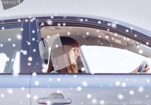 Image of close up of smiling businesswoman driving car