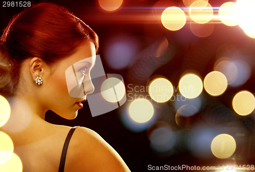 Image of woman in evening dress wearing diamond earrings