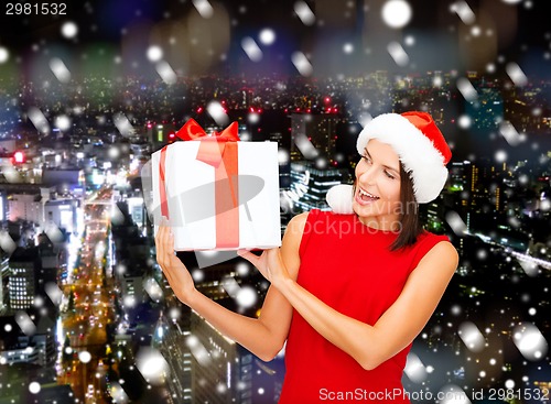 Image of smiling woman in red dress with gift box