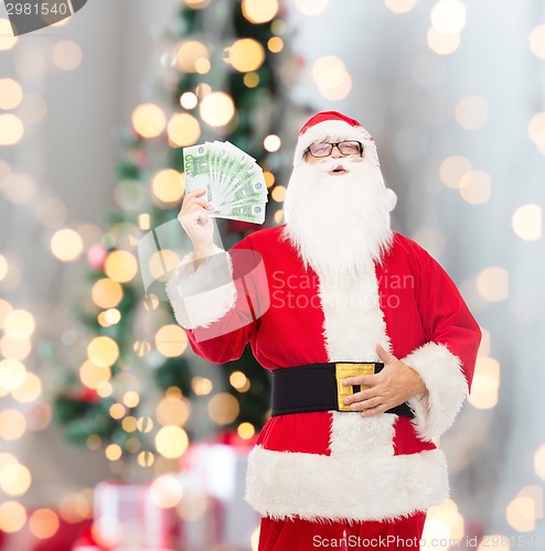 Image of man in costume of santa claus with euro money