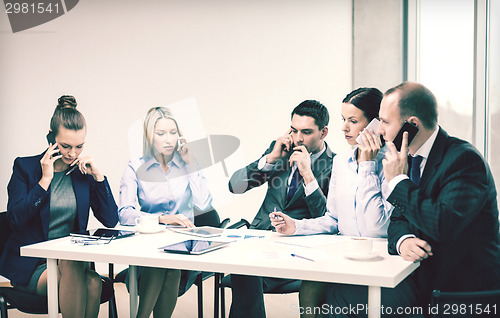 Image of business team with smartphones having conversation