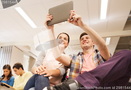 Image of group of smiling students with tablet pc