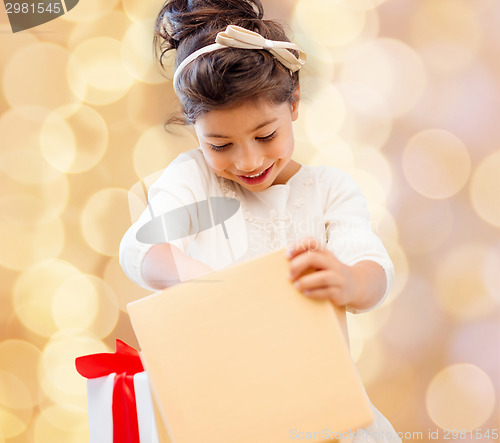 Image of smiling little girl with gift box