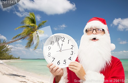Image of man in costume of santa claus with clock