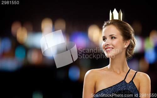 Image of smiling woman in evening dress wearing crown