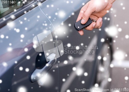 Image of close up of man with car key outdoors