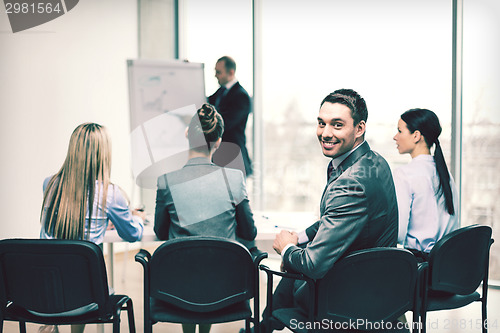 Image of businessman with team in office