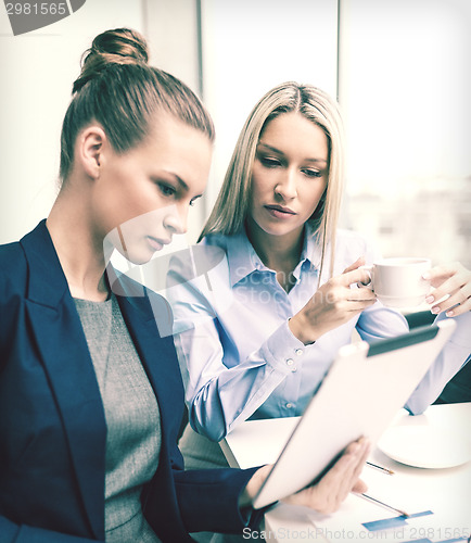 Image of business team with tablet pc having discussion