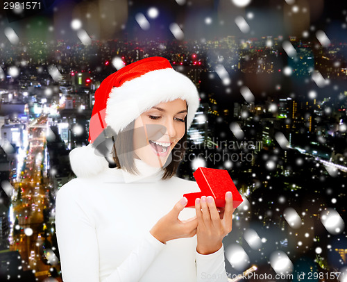 Image of smiling woman in santa helper hat with gift box