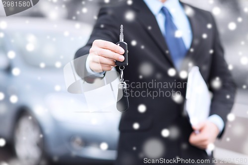 Image of close up of man with car key outdoors