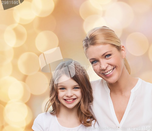 Image of smiling mother and little girl