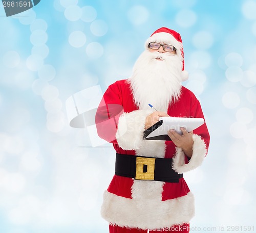 Image of man in costume of santa claus with notepad