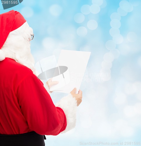 Image of man in costume of santa claus with letter