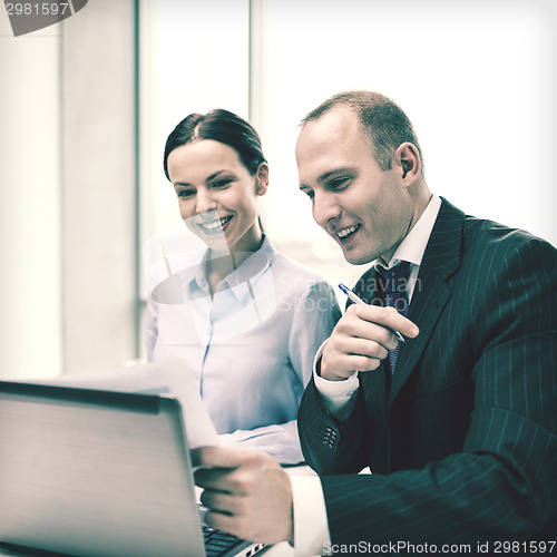 Image of businessman and businesswoman having discussion