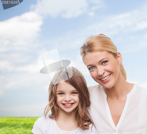 Image of smiling mother and little girl