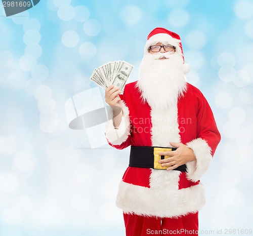 Image of man in costume of santa claus with dollar money