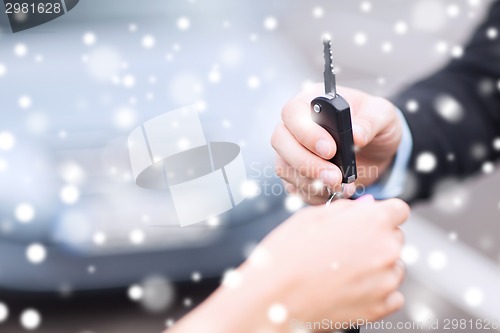 Image of close up of man with car key outdoors