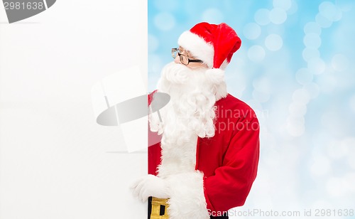 Image of man in costume of santa claus with billboard