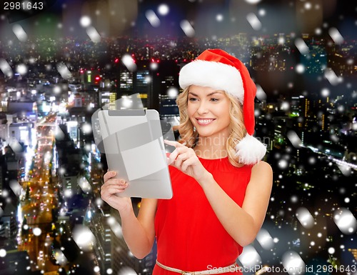 Image of woman in santa helper hat with tablet pc