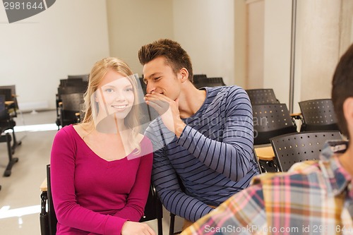 Image of group of smiling students in lecture hall