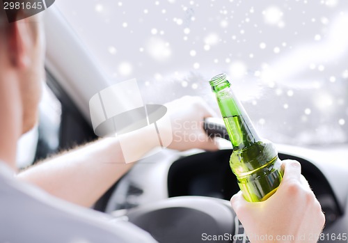 Image of close up of man drinking alcohol while driving car