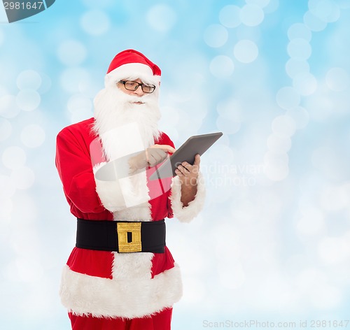 Image of man in costume of santa claus with tablet pc