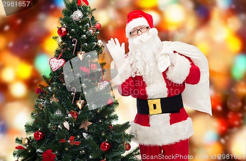 Image of santa claus with bag and christmas tree