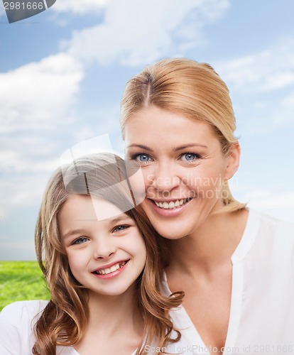 Image of smiling mother and little girl