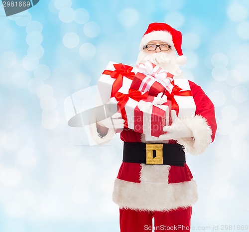 Image of man in costume of santa claus with gift boxes