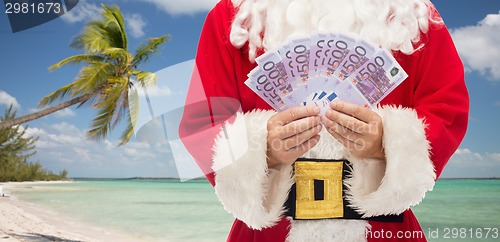 Image of close up of santa claus with euro money