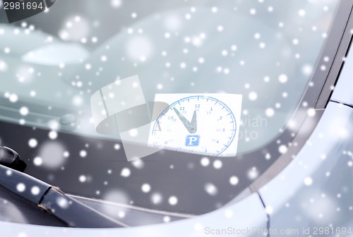 Image of close up of parking clock on car widow