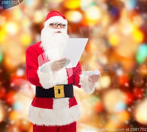 Image of man in costume of santa claus with letter