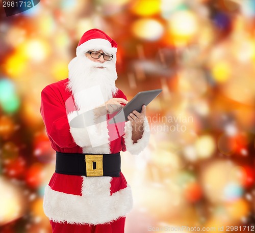 Image of man in costume of santa claus with tablet pc