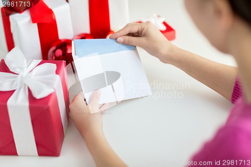 Image of close up of woman with letter and presents