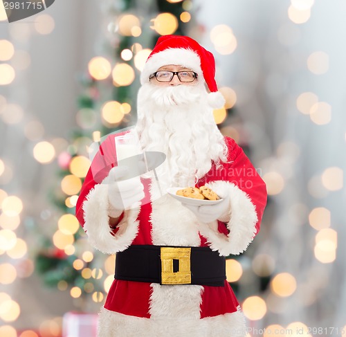 Image of santa claus with glass of milk and cookies