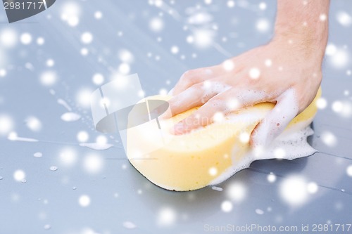 Image of close up of man washing a car