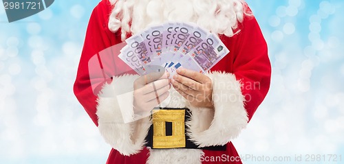 Image of close up of santa claus with euro money