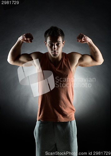 Image of young man showing biceps