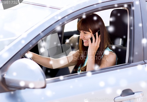 Image of close up of woman with smartphone driving car