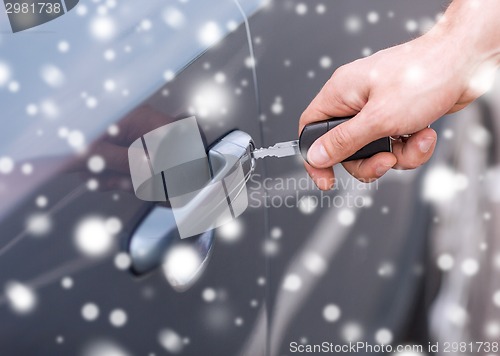 Image of close up of man with car key outdoors