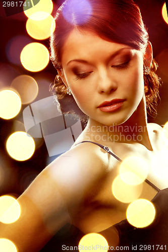 Image of woman in evening dress wearing diamond earrings