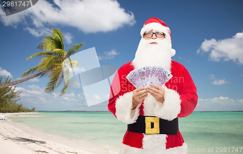 Image of man in costume of santa claus with euro money