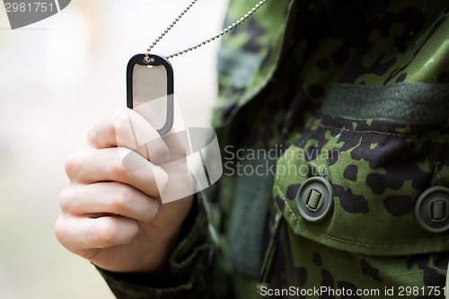 Image of close up of young soldier in military uniform