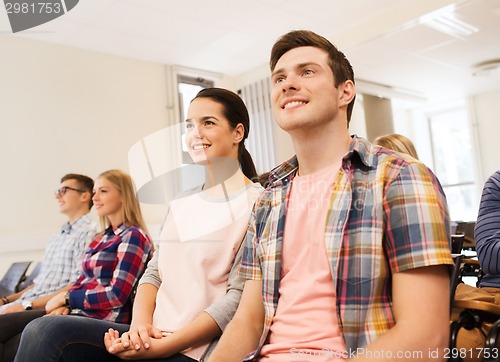 Image of group of smiling students in lecture hall